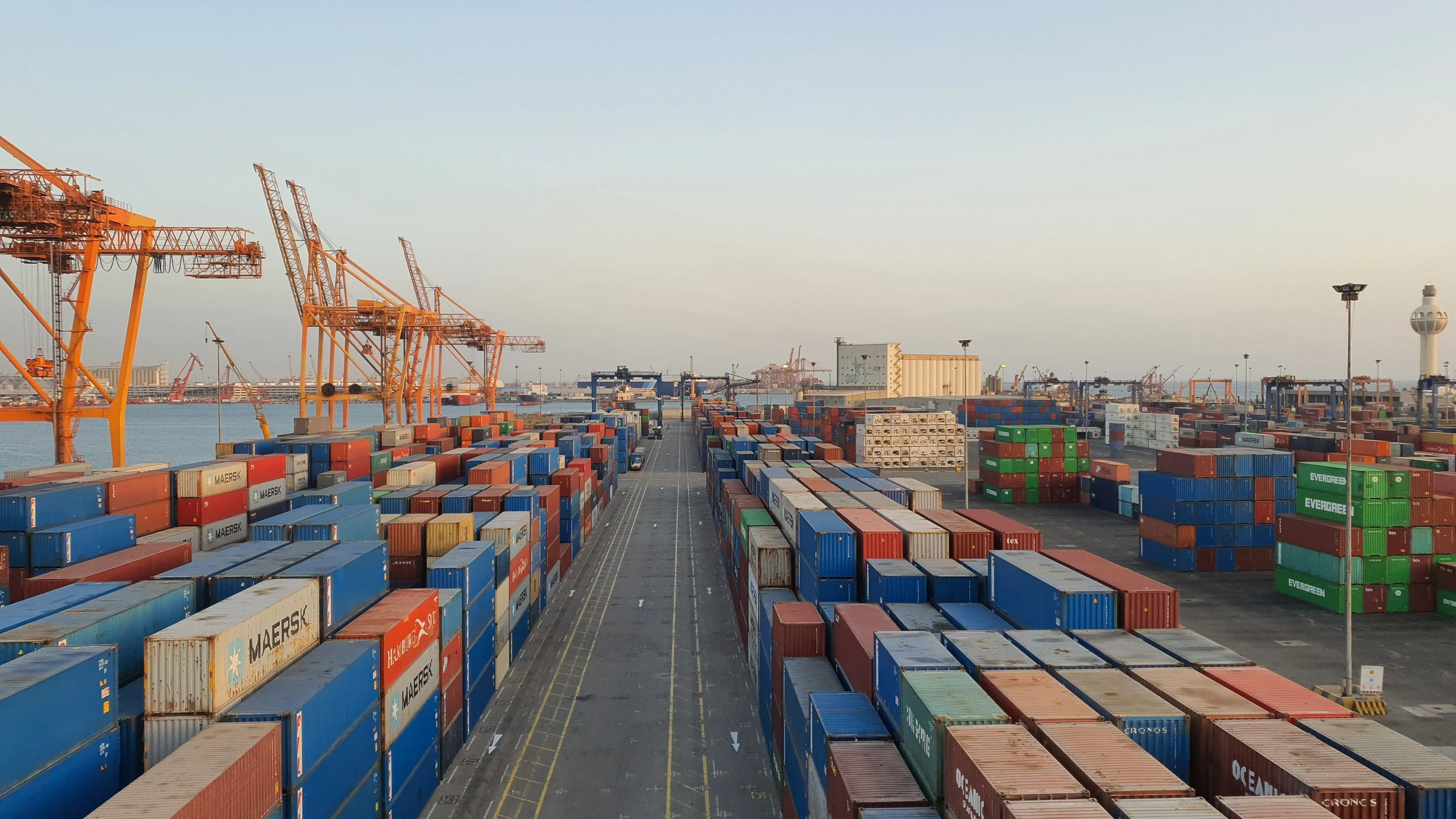 Cargo containers and cranes at a port terminal.