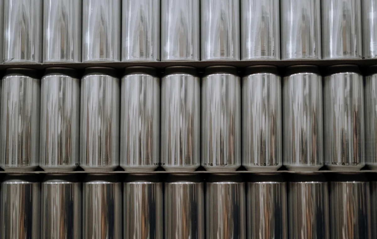 Tin cans on a production line, showing a plausible downstream use context for tin mill products.
