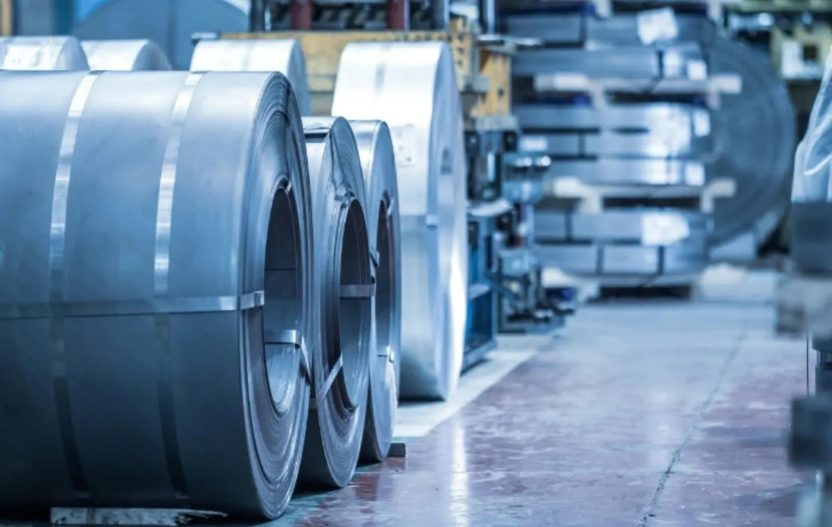 Hot-rolled steel coils on a factory line awaiting trade-remedy scope and origin checks.